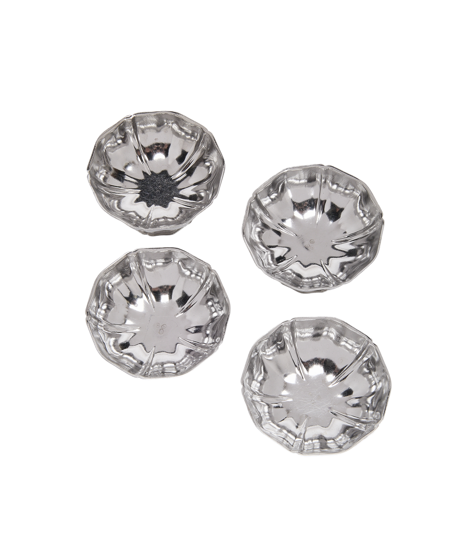 Vintage French fluted steel cups, set of four, aerial view, reflective surface.