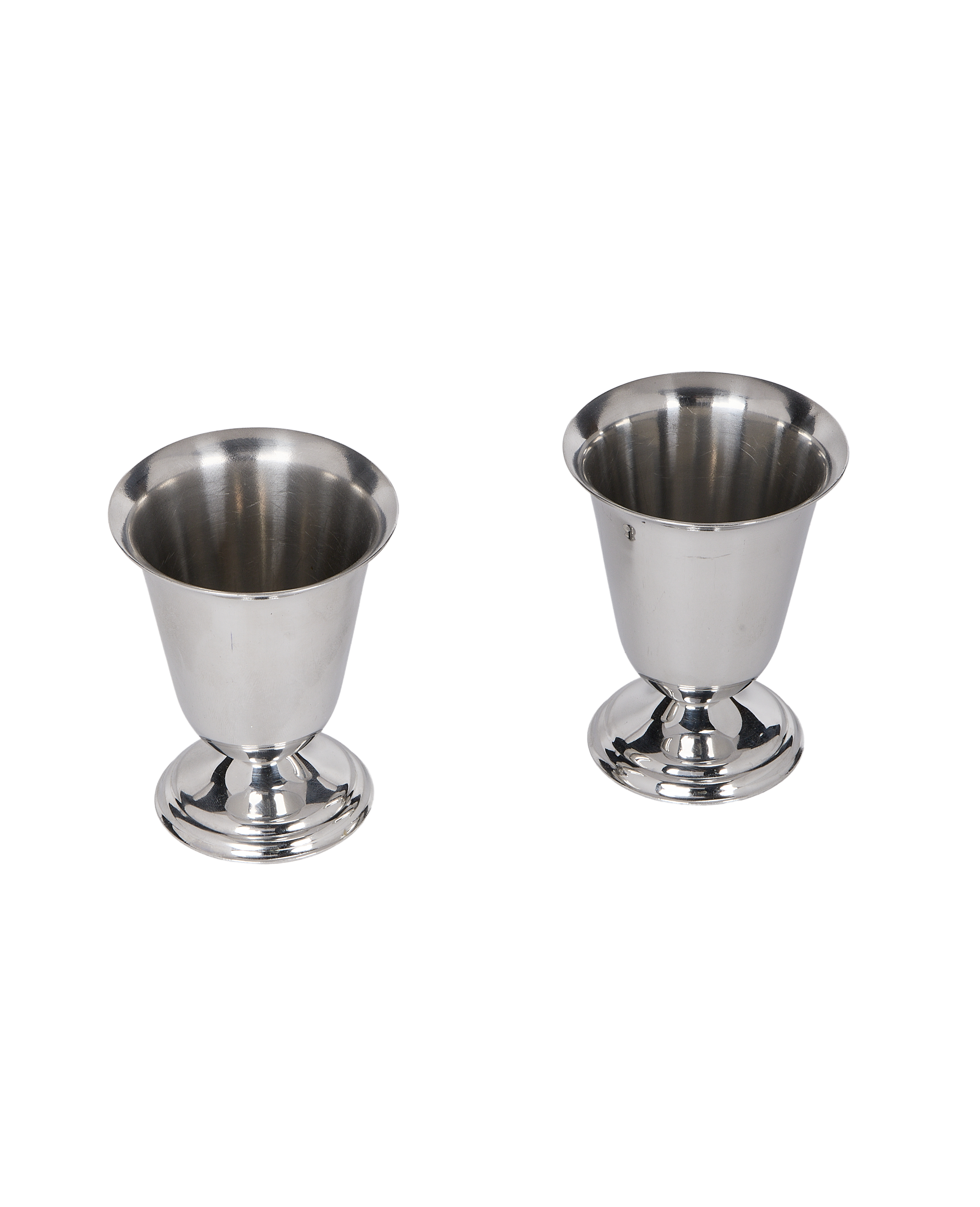 Pair of vintage French steel cups, showing overall form and footed bases.