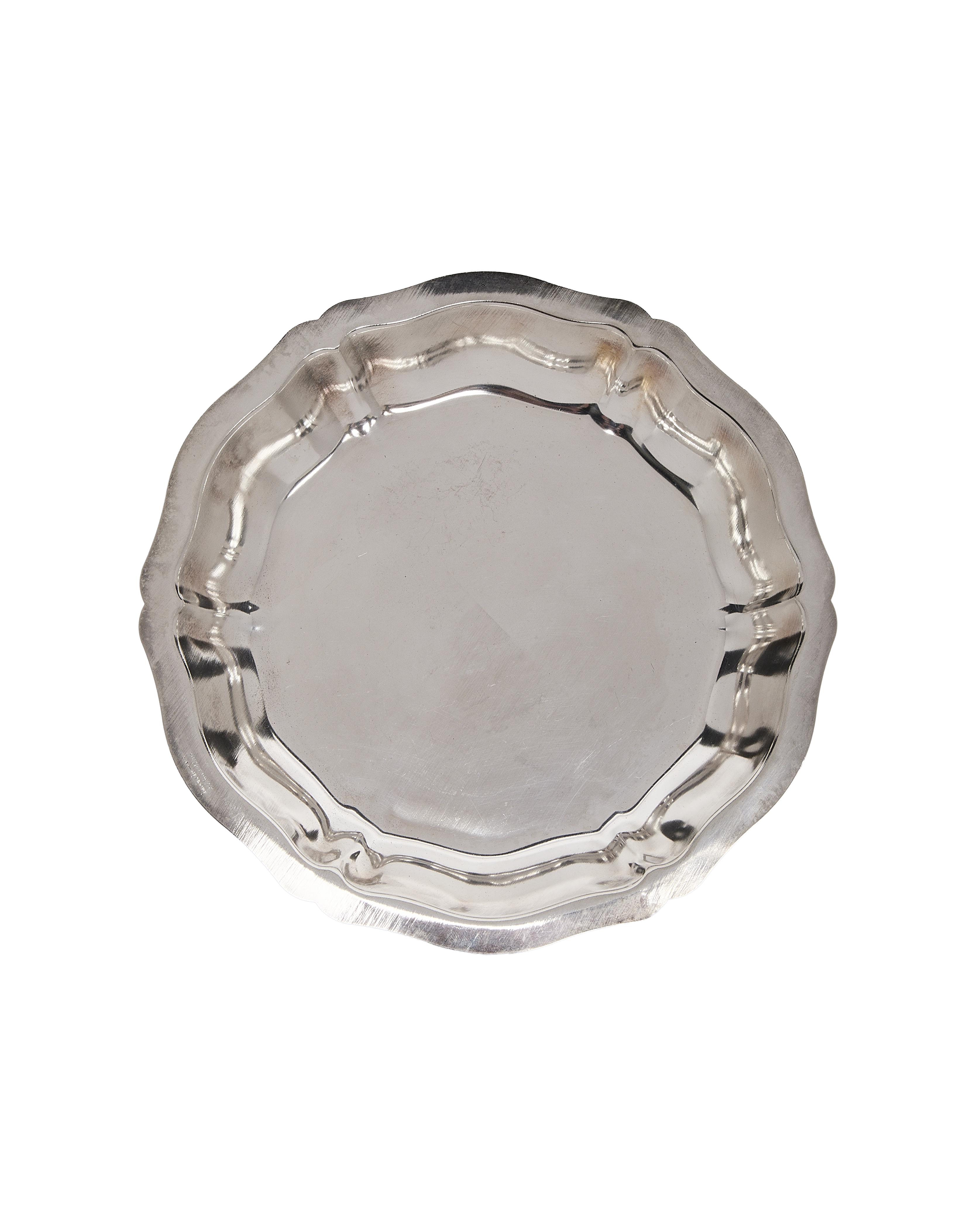 Vintage French metal dish with scalloped edges and light surface scratches, top-down view.