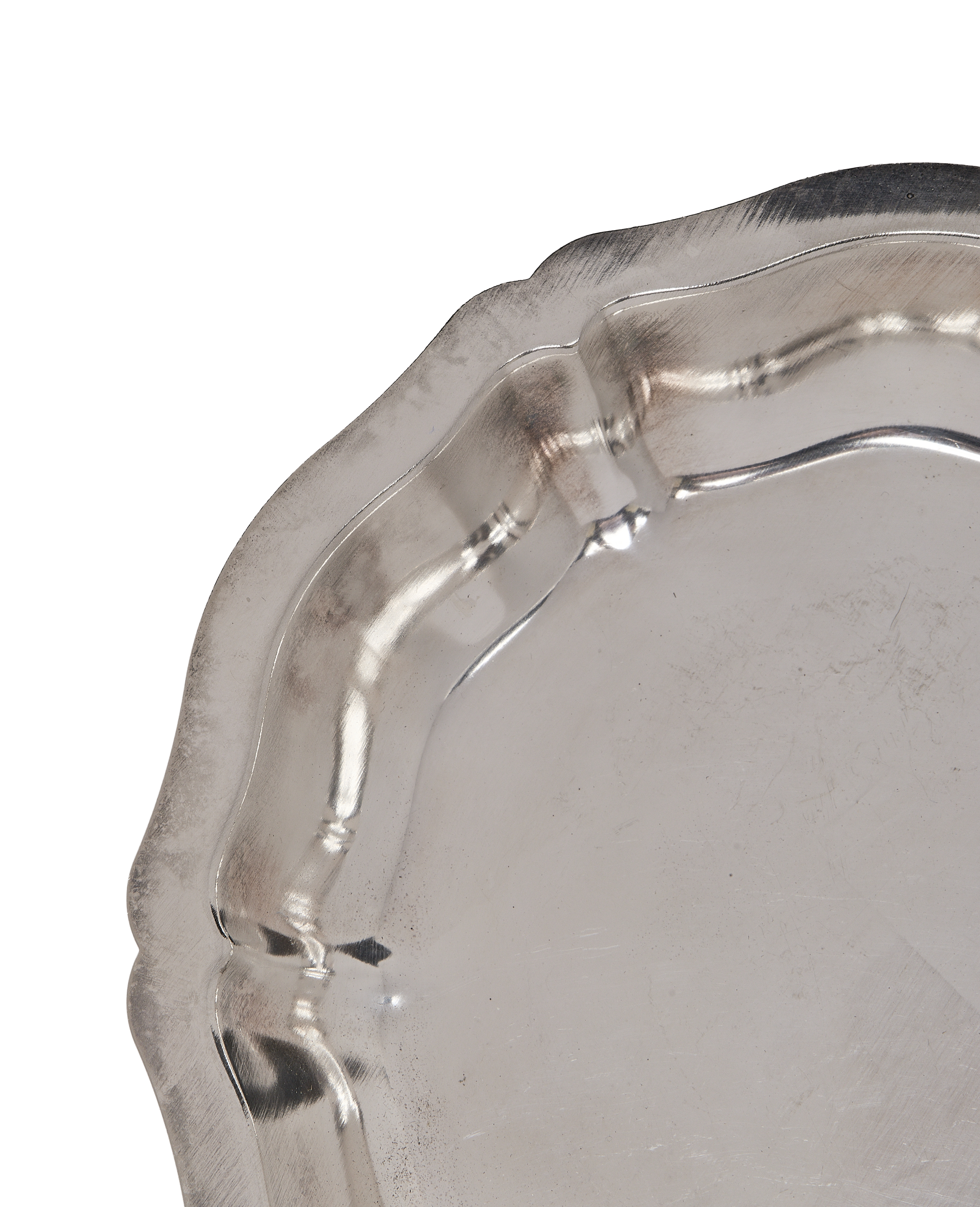 Vintage French metal dish, close-up of wavy crimped edge, showing aged silver finish.