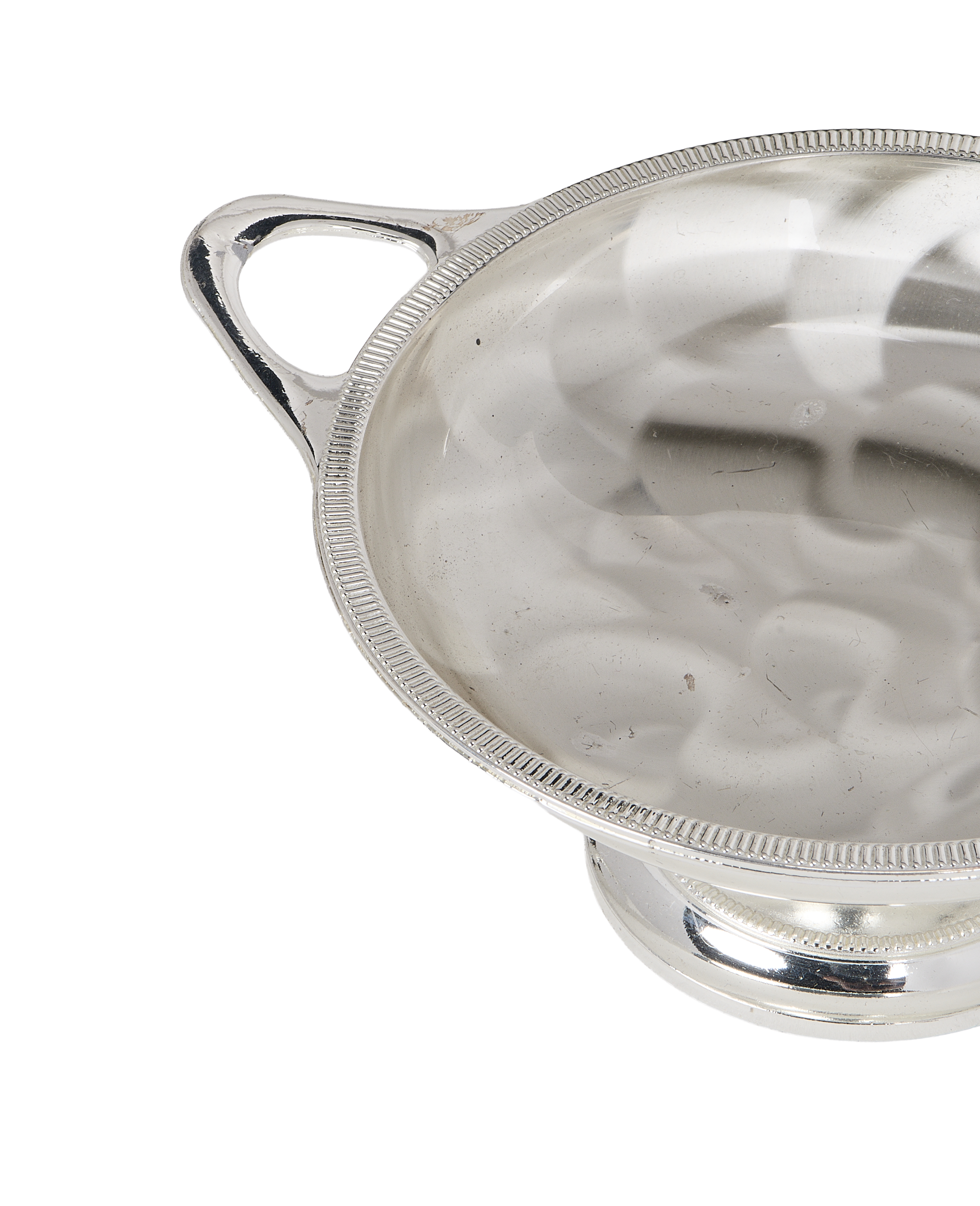 Vintage silver pedestal dish, handles, and textured rim detail.