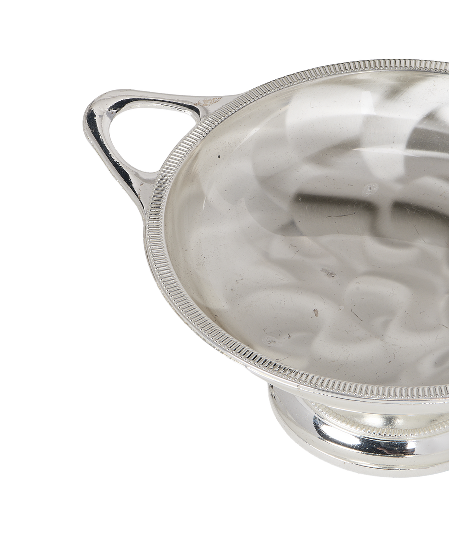 Vintage silver pedestal dish, handles, and textured rim detail.