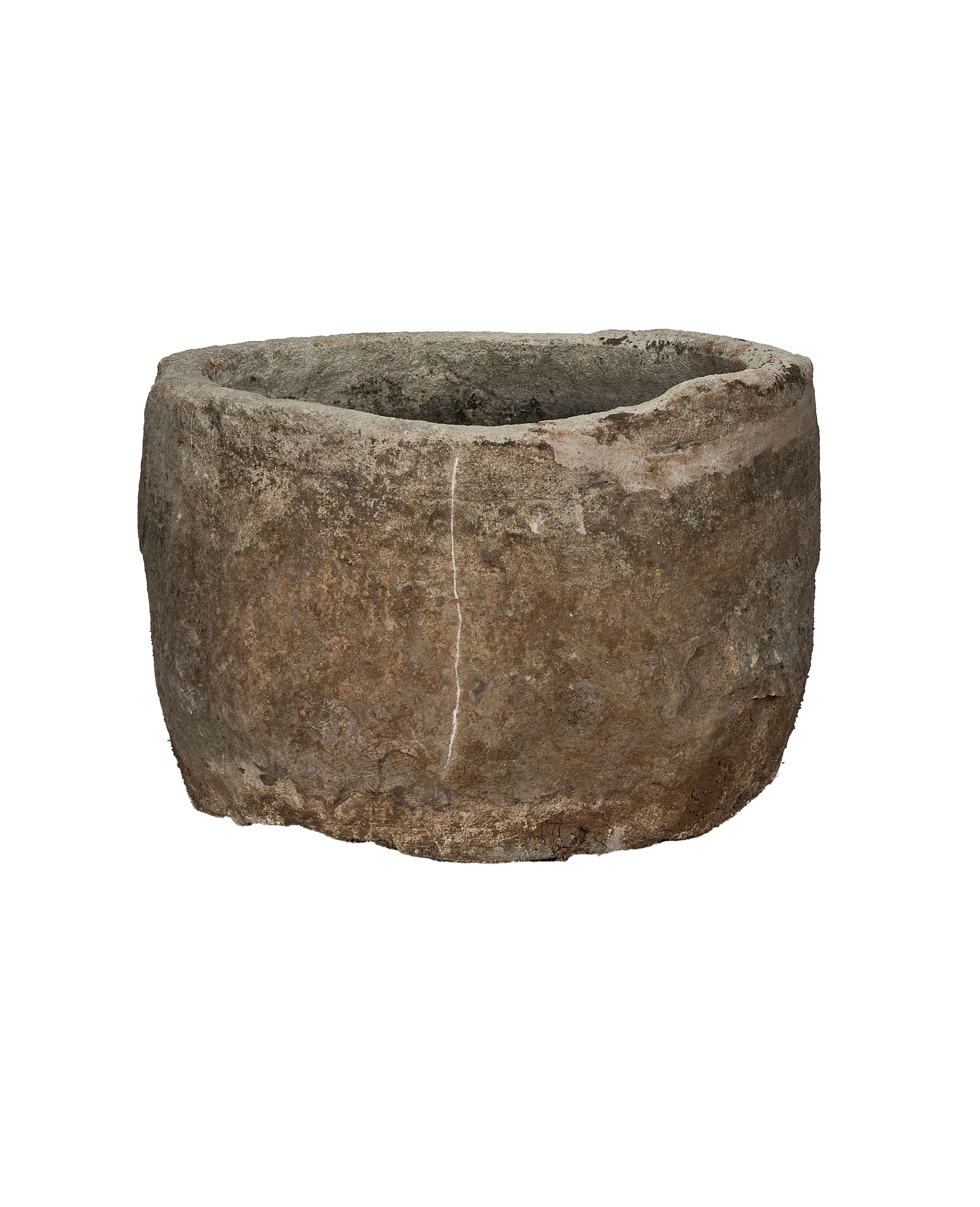 Vintage round limestone trough, full side view, showing weathered surface and a vertical crack.