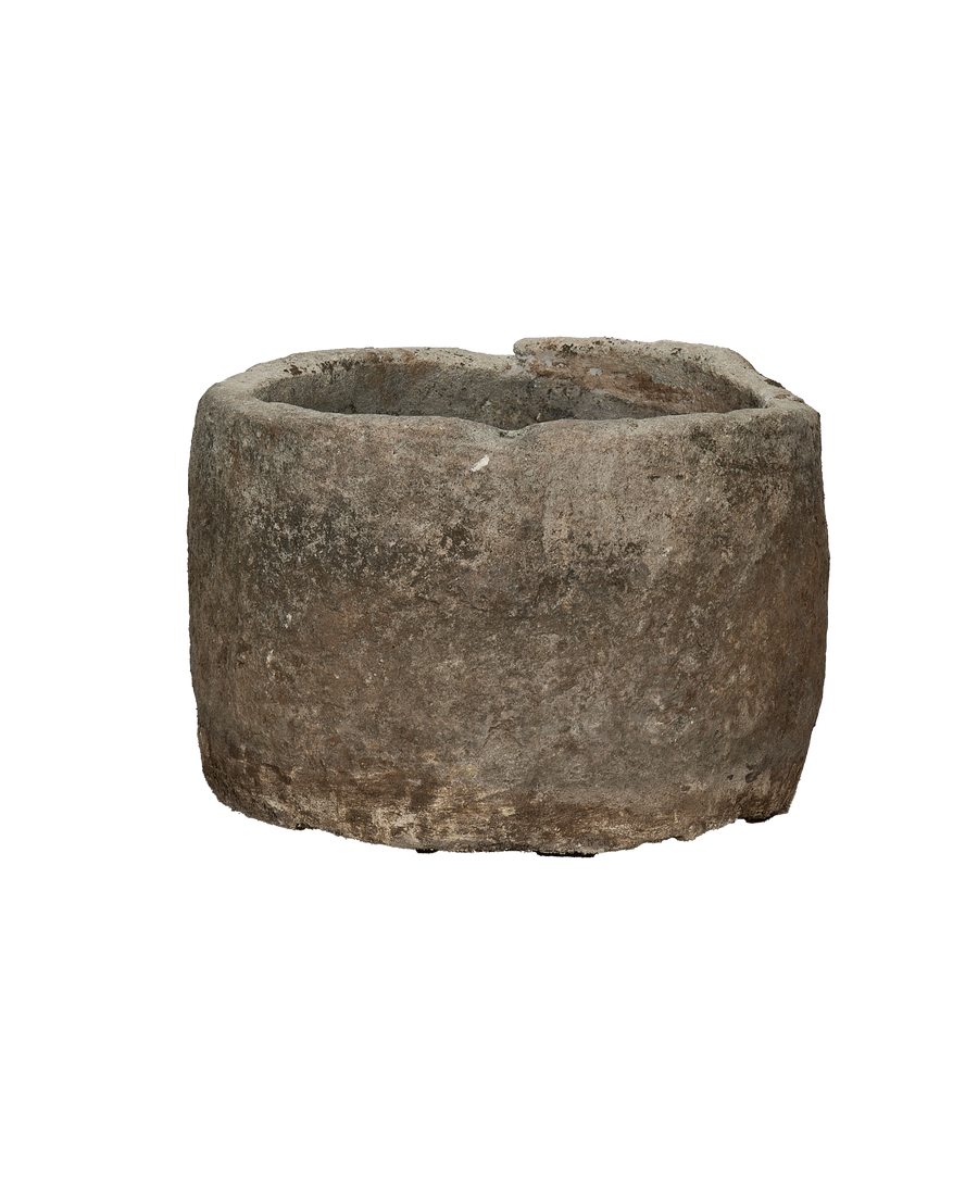 Vintage Indonesian limestone trough, showing a cracked, weathered top rim detail.