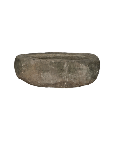 Vintage Indonesian oblong limestone trough, weathered gray, worn texture, showcased centrally against black.