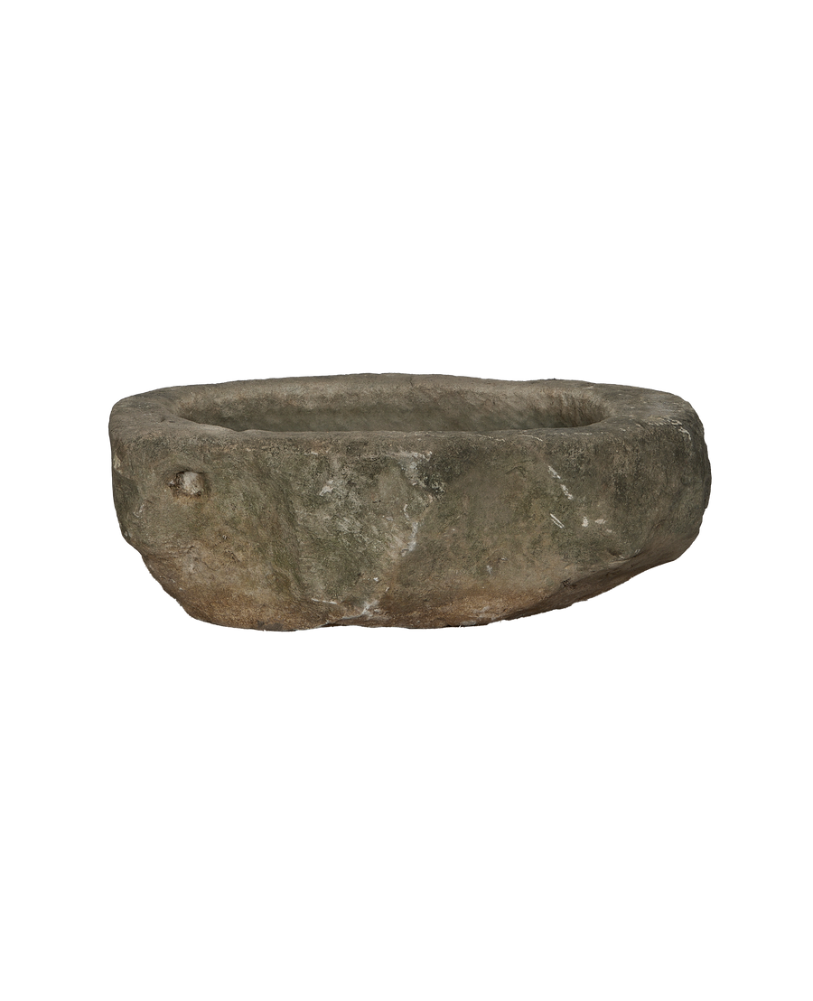Vintage Indonesian oblong limestone trough, dark weathered texture, with natural aged pitting and unique uneven rim.
