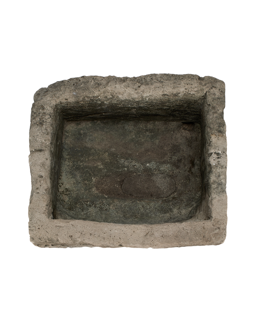 Vintage rectangular limestone trough, top view reveals rustic interior and textured edges.