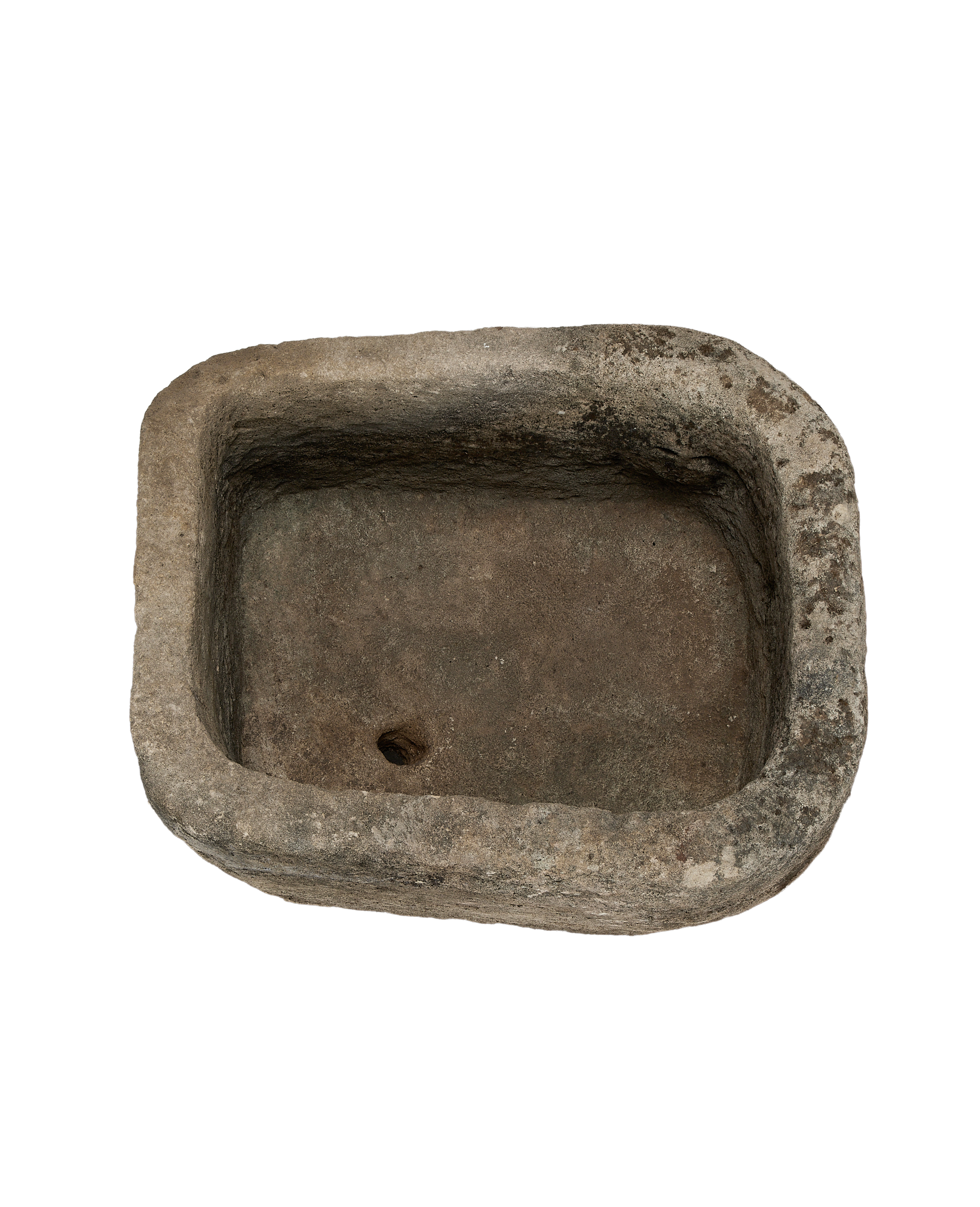 Vintage Indonesian oblong limestone trough, dark interior, showing drain hole and textured surface.