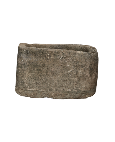 Oblong vintage Indonesian limestone trough with textured gray surface, dark weathered patina.