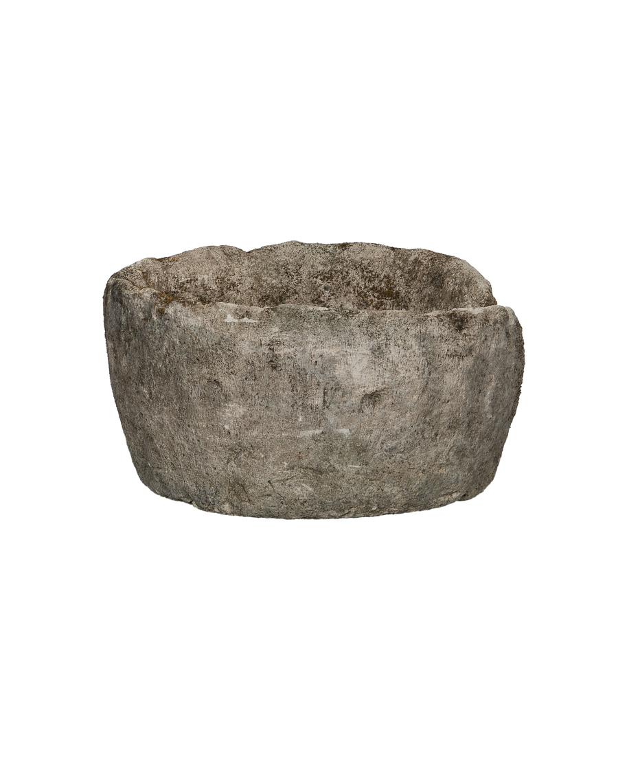 Vintage Indonesian round limestone trough, showing its rough texture and patinated surface.
