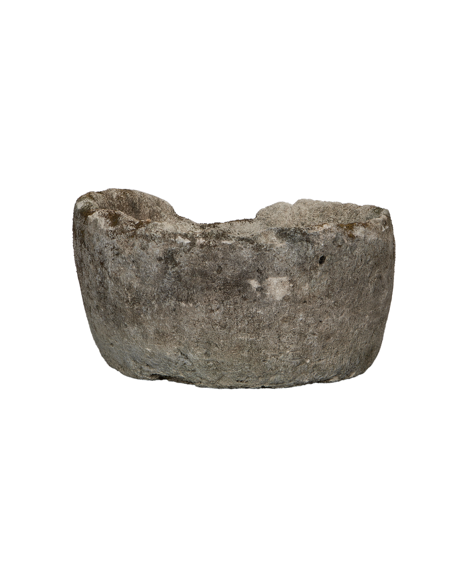 Vintage Indonesian round limestone trough, side profile, rough weathered texture, unique uneven rim.