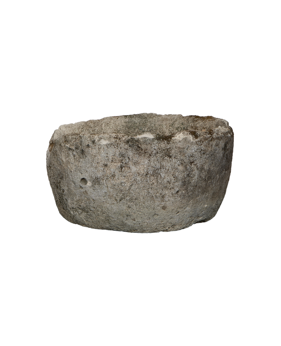 Vintage round limestone trough, aged grey surface revealing natural texture and a small drain hole.
