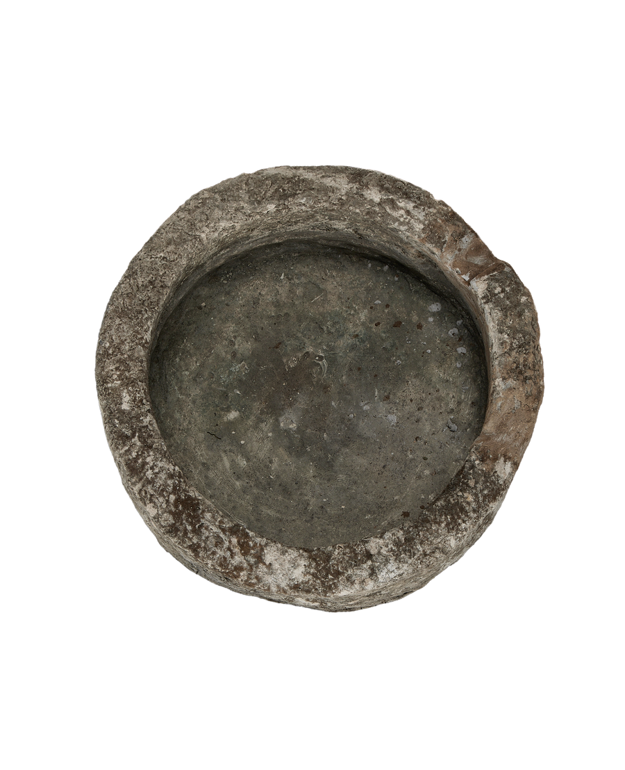 Vintage round Indonesian limestone trough, top-down view showing textured rim and weathered interior.