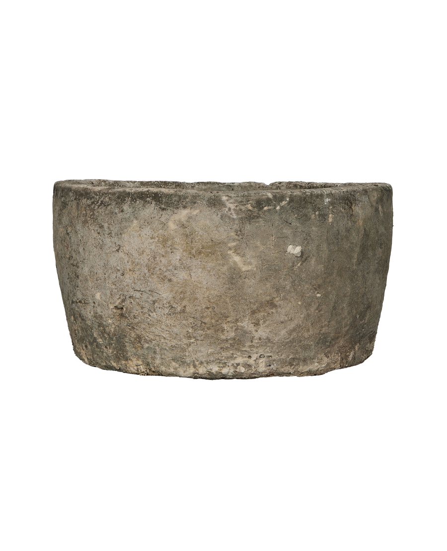 Vintage Indonesian limestone trough, showing weathered texture and unique organic rim.