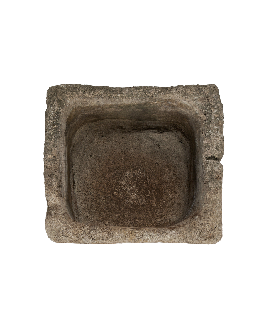 Vintage Indonesian limestone trough, top-down view showing weathered texture and square shape.