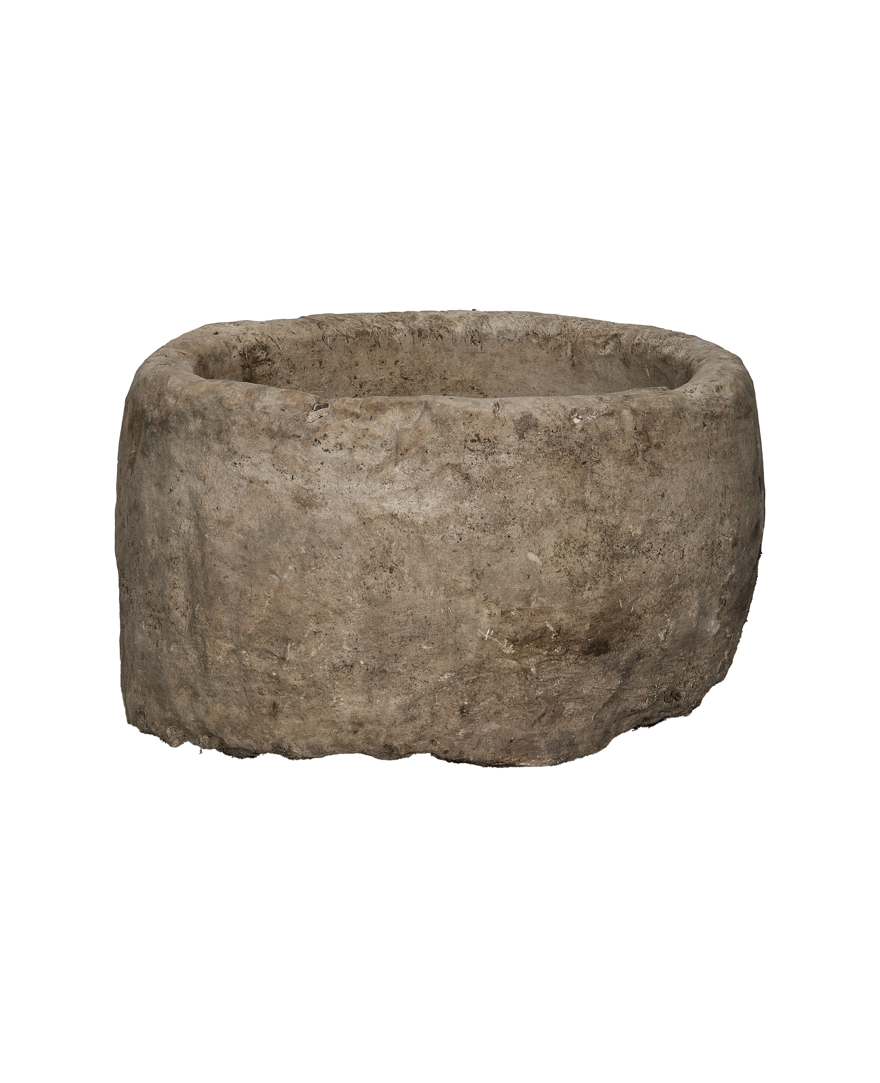 Vintage, round Indonesian limestone trough showing its textured, weathered exterior from the side.
