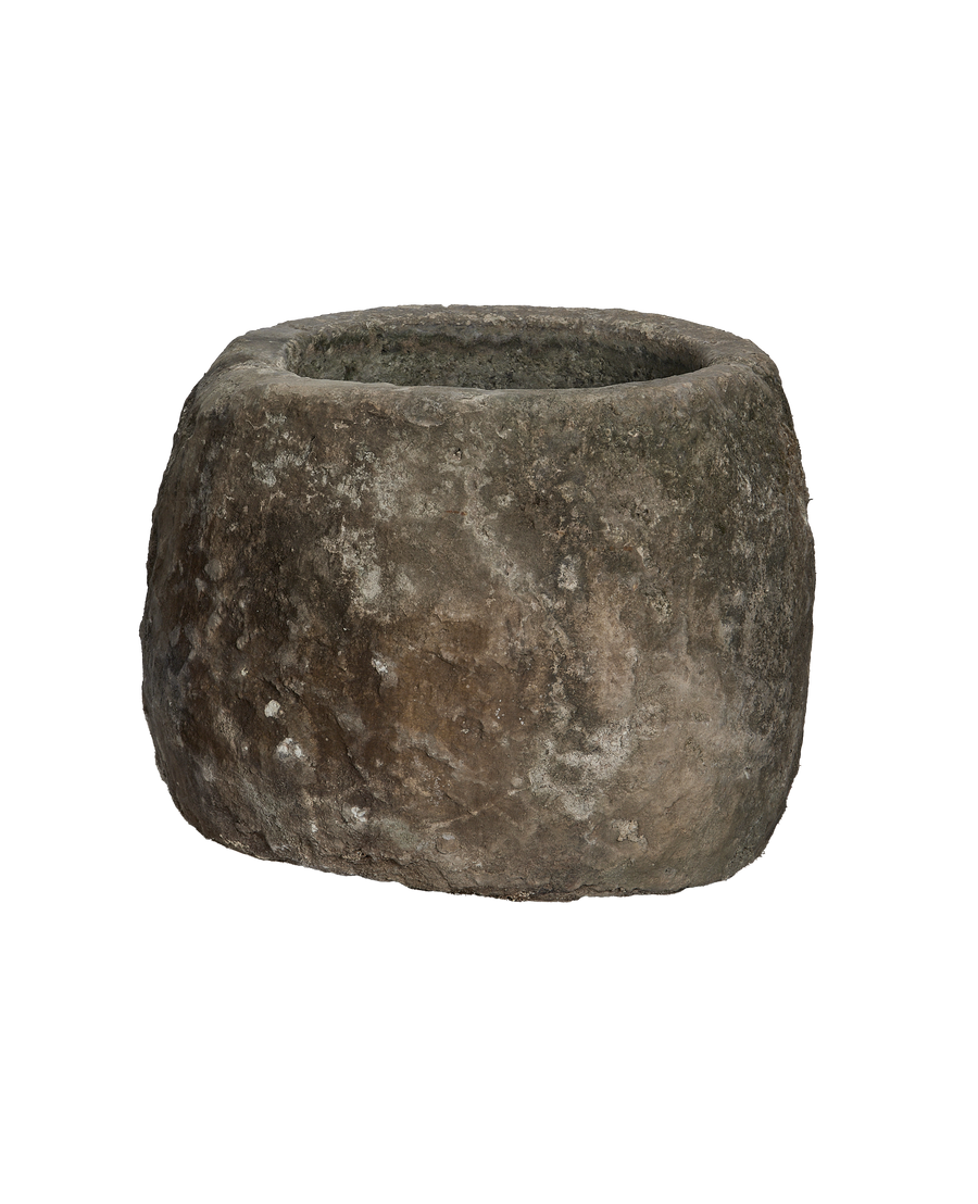 Vintage Indonesian round limestone trough, showing its rough, weathered exterior texture.