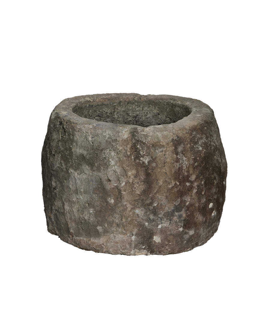 Vintage Indonesian round limestone trough, full external view highlighting rough, weathered texture and original condition.