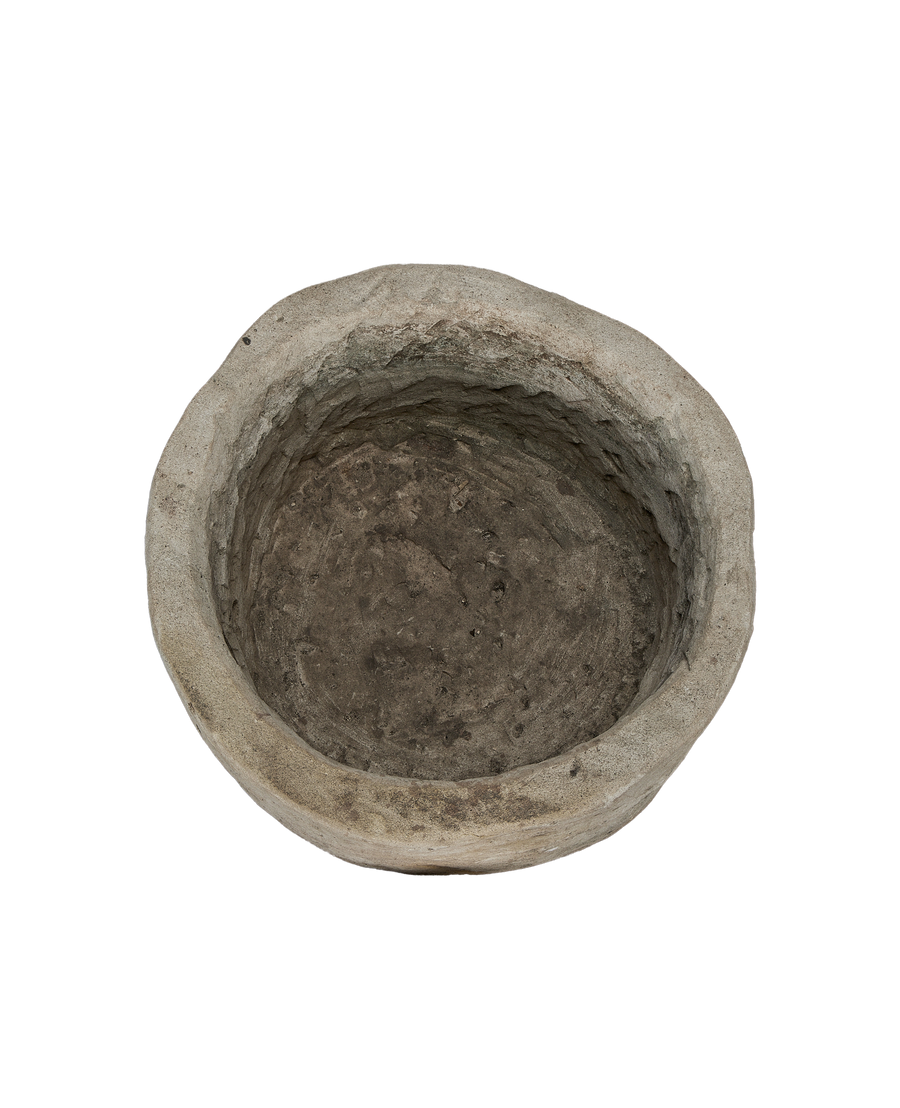Round vintage Indonesian limestone trough from above, showing interior texture and worn rim.