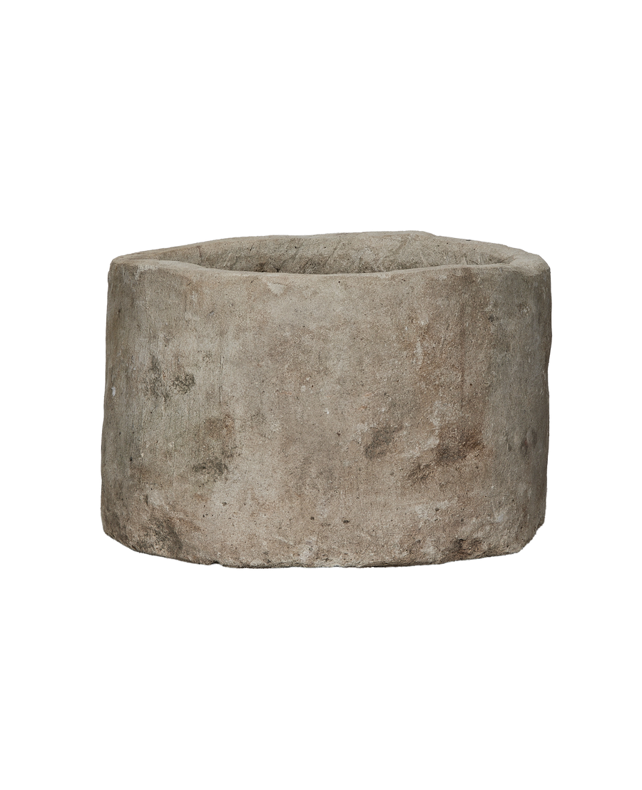 Vintage Indonesian limestone trough (OAK) side view, showing weathered gray-brown texture.
