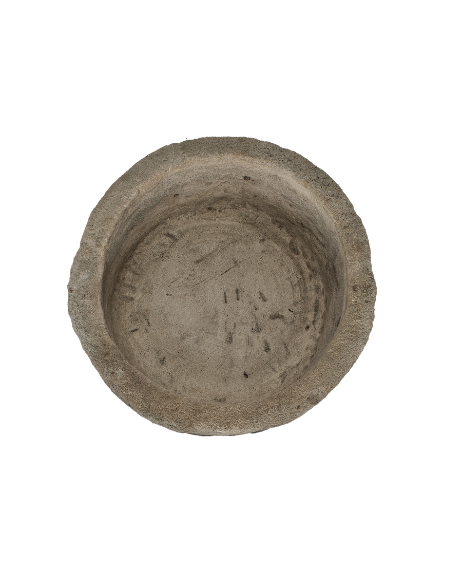 Vintage Indonesian round limestone trough, top-down view showing interior texture and aged surface.
