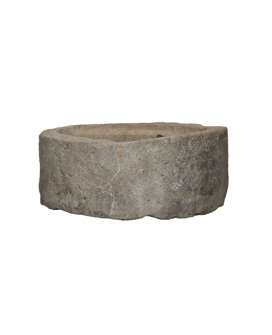 Round vintage Indonesian limestone trough showcasing natural texture and weathered crack detail.