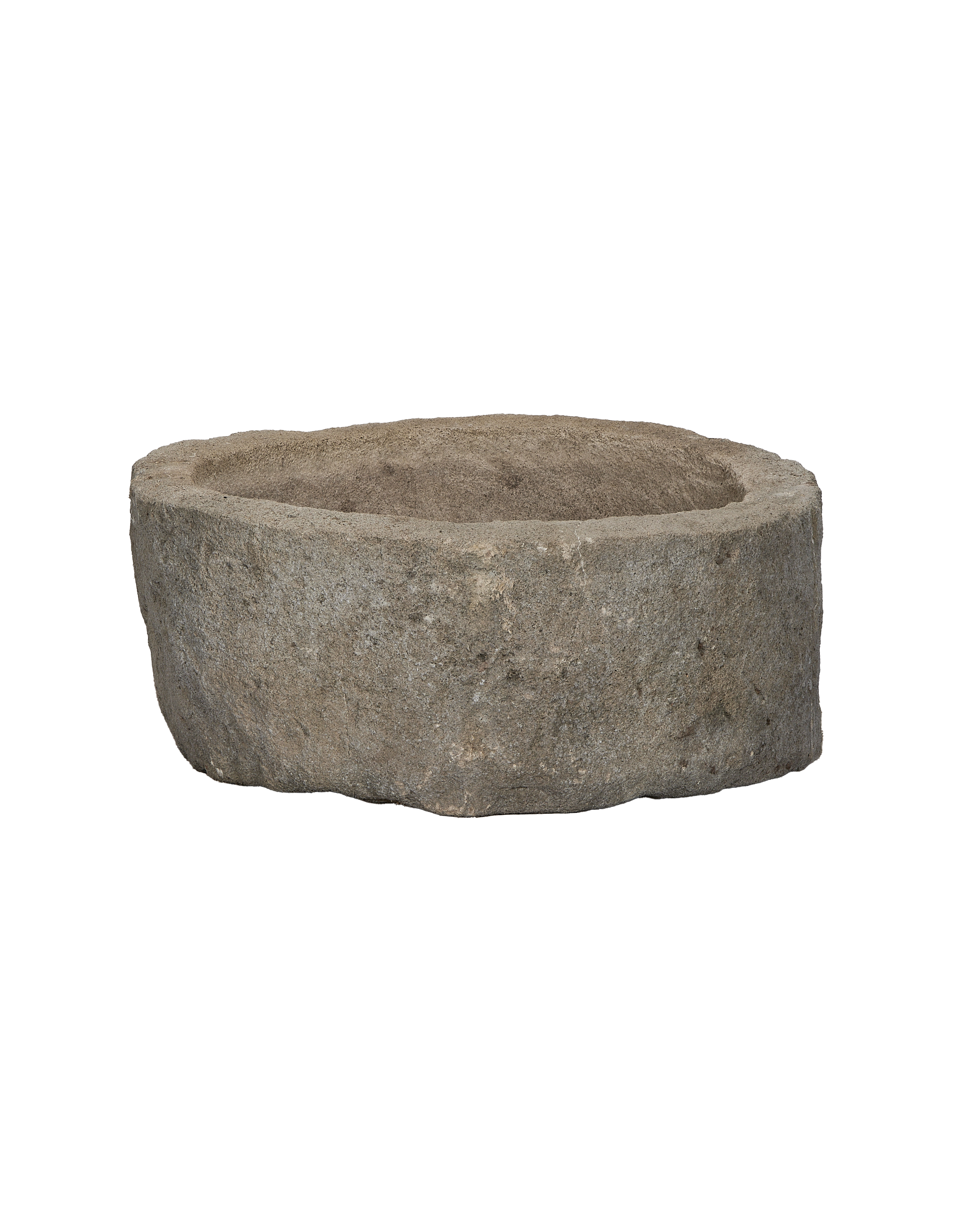 Vintage Indonesian limestone trough, round, showing detailed rough-hewn exterior texture.