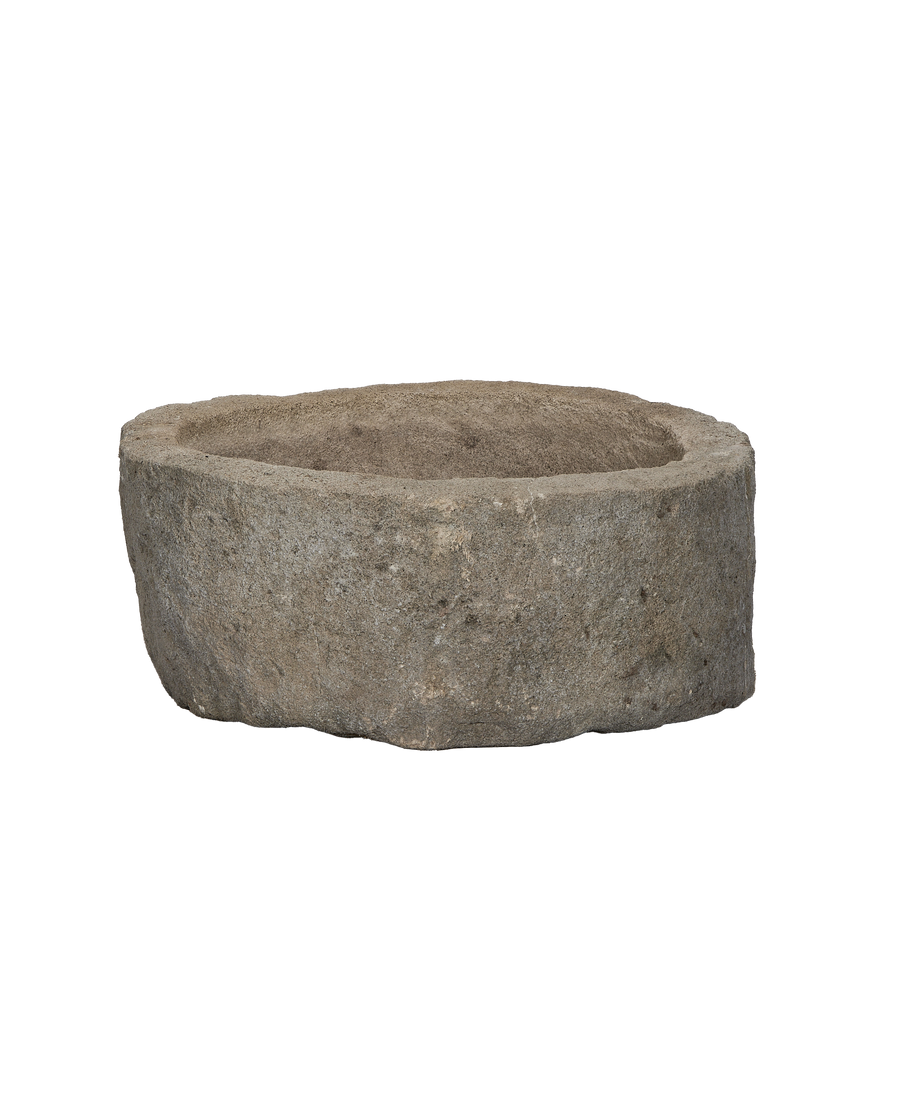 Vintage Indonesian limestone trough, round, showing detailed rough-hewn exterior texture.