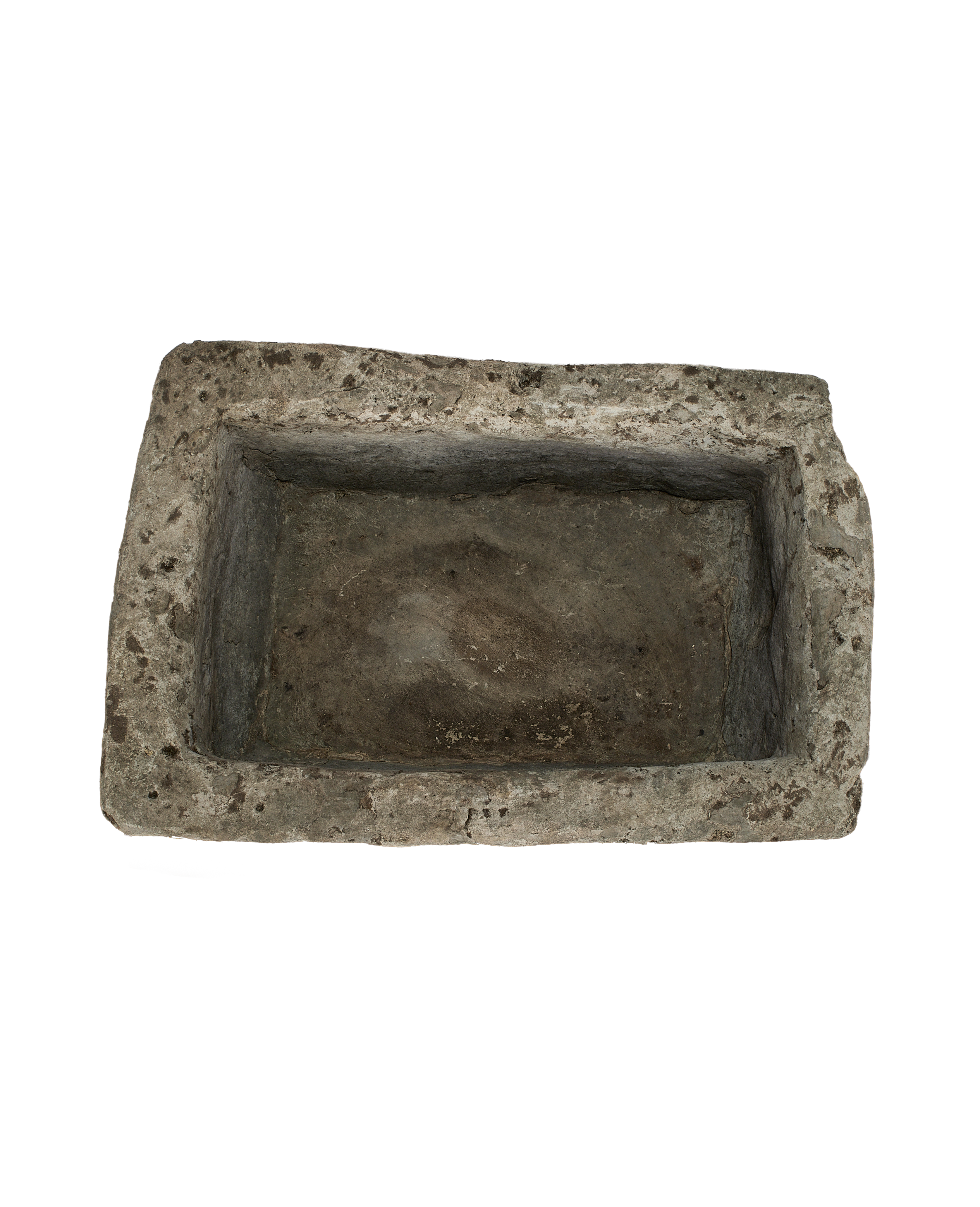 Vintage limestone trough, top-down view showing interior depth and rough texture.
