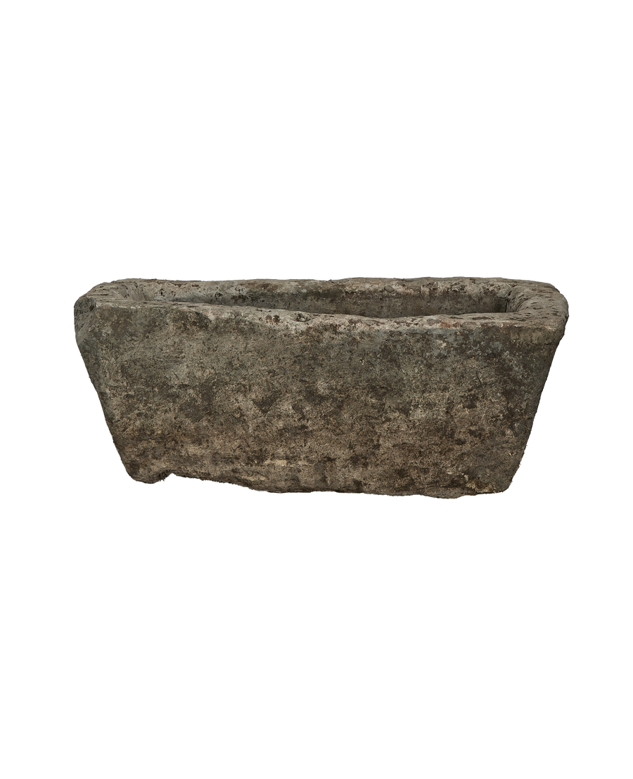 Vintage weathered Indonesian limestone trough from an elevated side angle, showcasing texture.