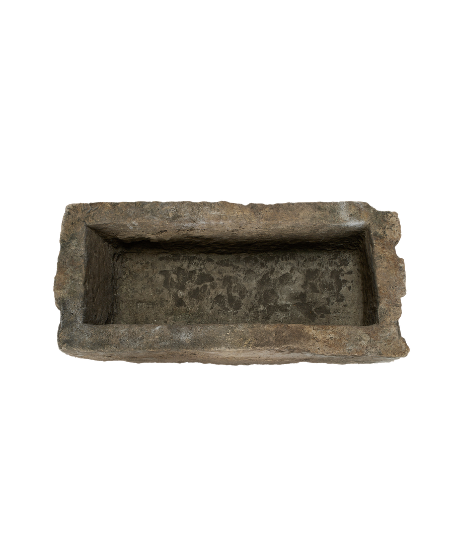 Vintage rectangular Indonesian limestone trough, top-down view highlighting rough, weathered interior texture.