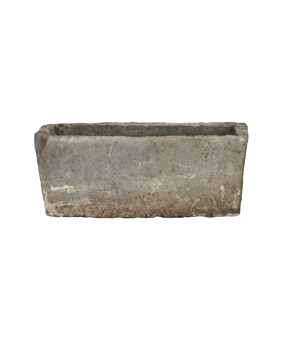 Vintage rectangular limestone trough, showing weathered texture and natural imperfections, front view.