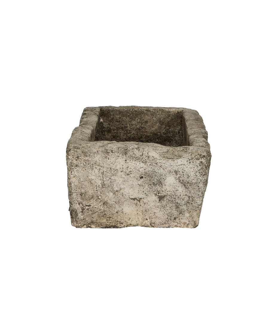 Vintage Indonesian limestone trough, top-down view showing rectangular opening, rough texture.