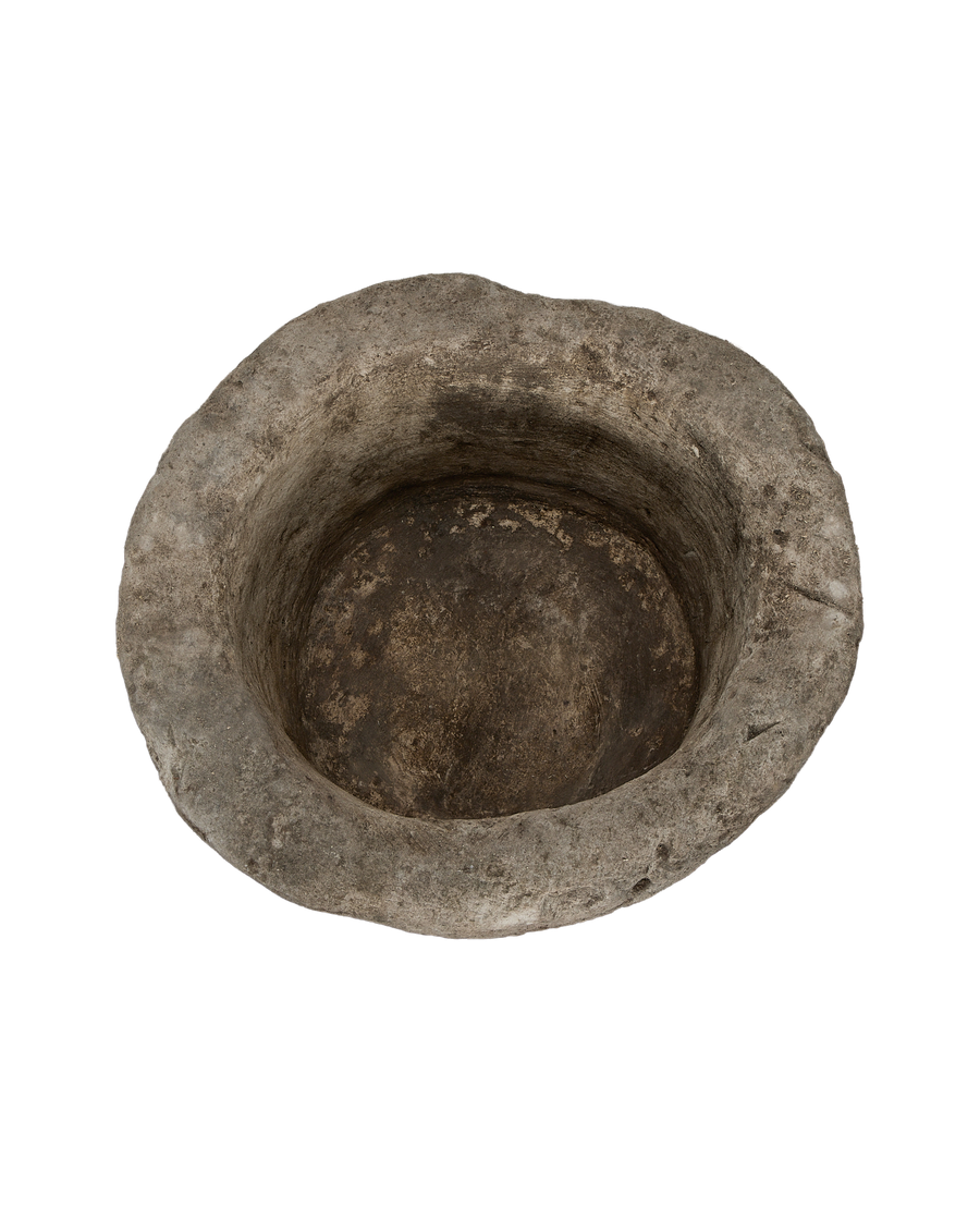 Vintage Indonesian round limestone trough, showing weathered interior basin from overhead angle.