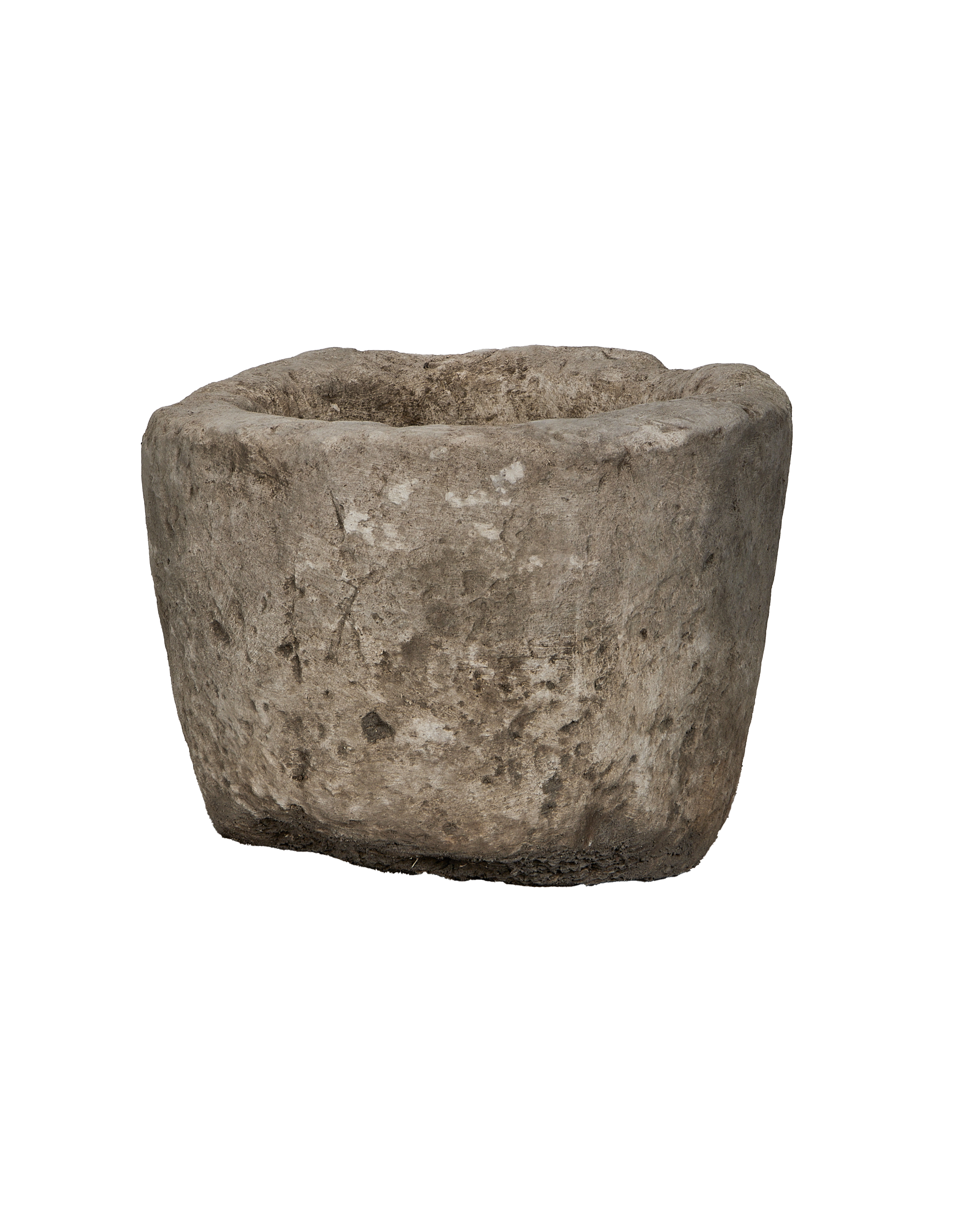 Vintage Indonesian limestone trough, showing rough, weathered texture and imperfections, side angle.