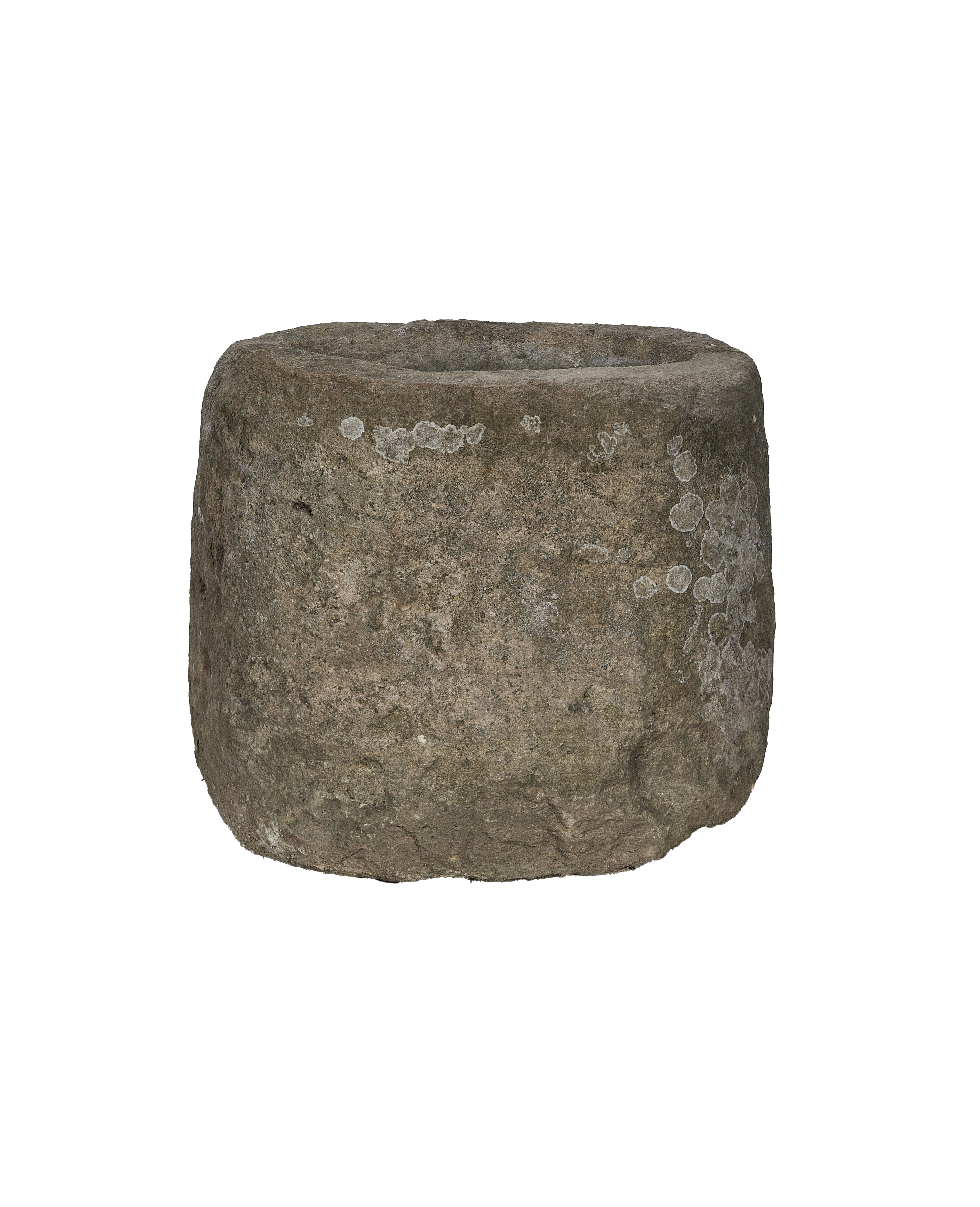 Vintage limestone trough from Indonesia, showing side view with rough texture and white lichen.