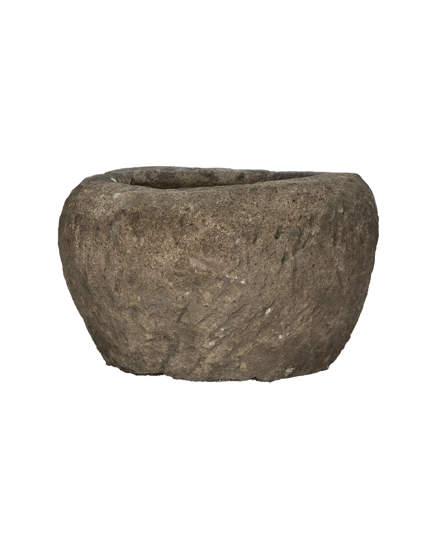 Vintage Indonesian limestone trough, displaying rugged texture and aged patina, side view.