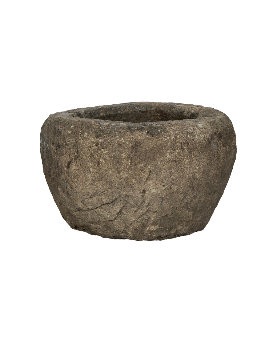Vintage round Indonesian limestone trough, showing textured side and weathered, aged condition.