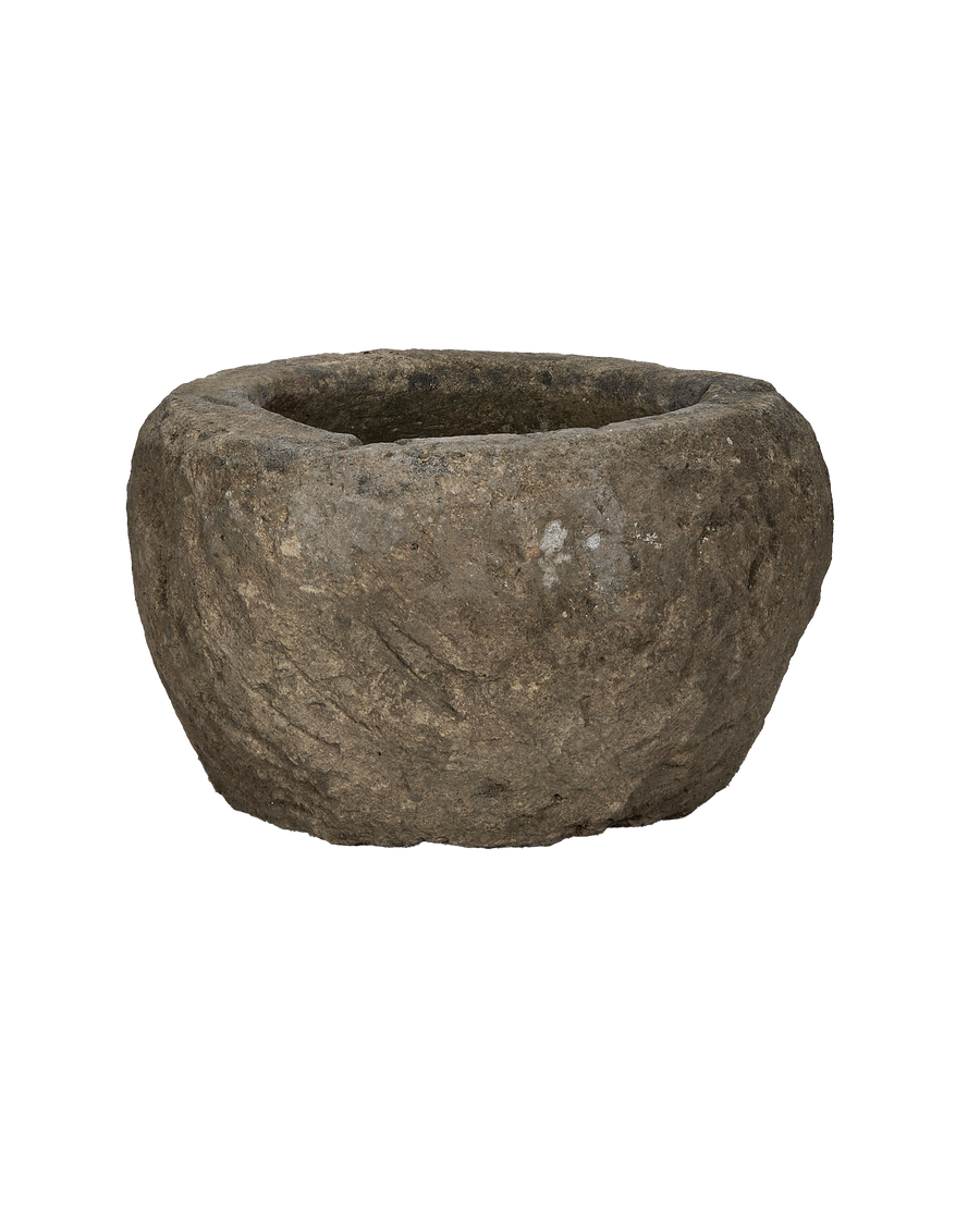 Vintage Indonesian round limestone trough, side profile, revealing natural rough texture and weathered finish.
