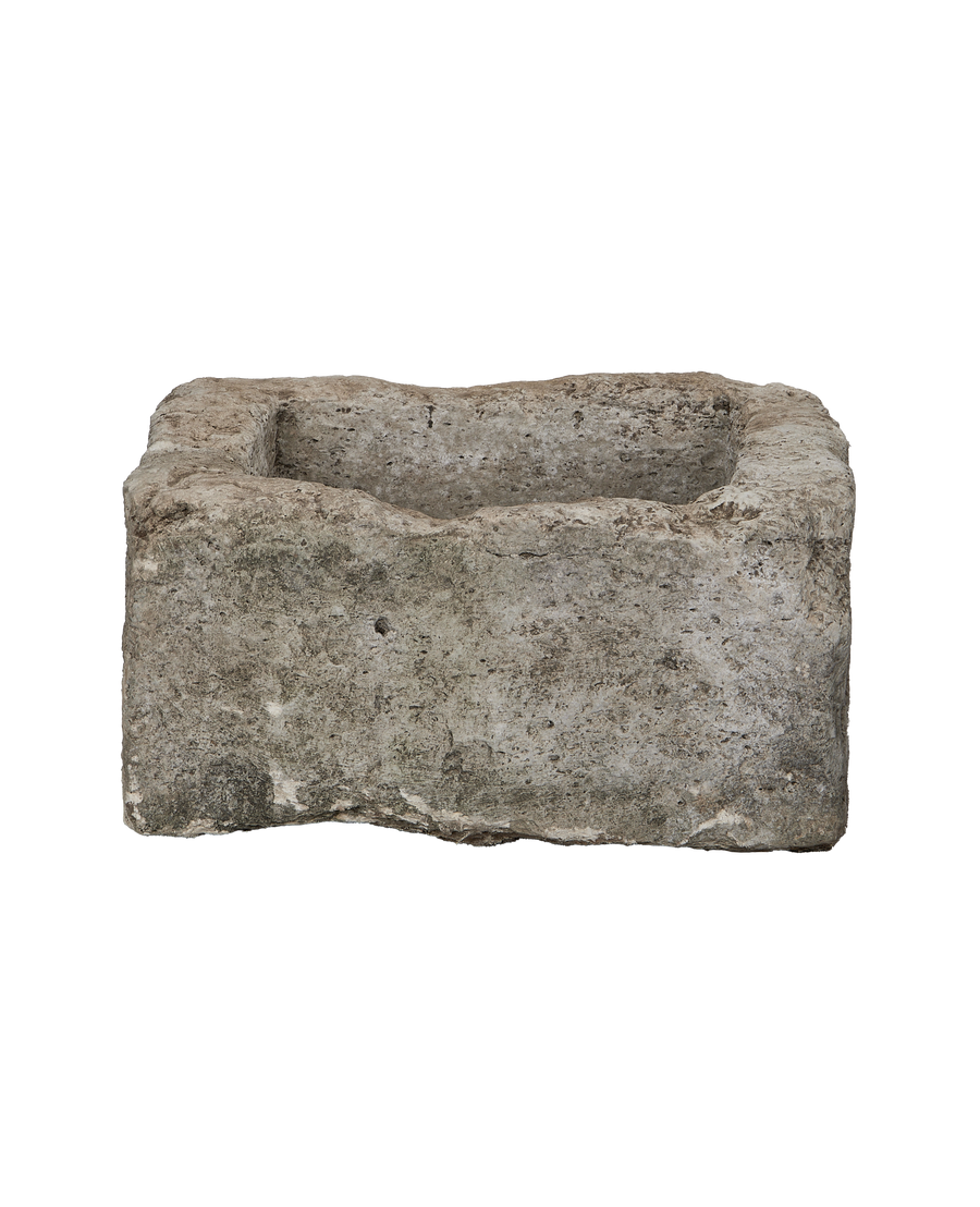 Square vintage Indonesian limestone trough, detailed texture of the weathered stone exterior.
