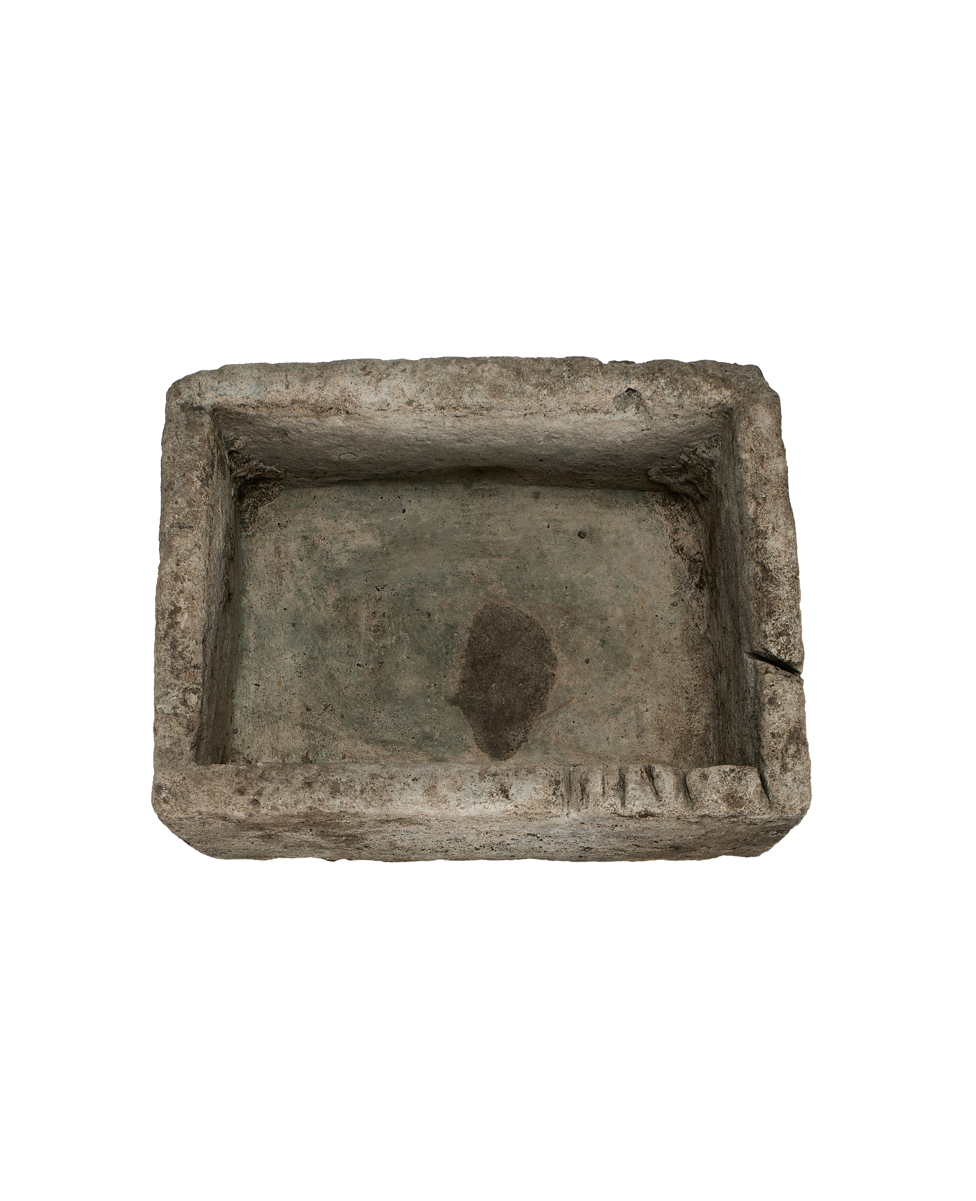 Vintage gray limestone trough from above, showcasing rough texture and weathered interior.