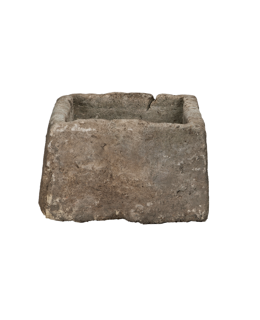 Vintage rectangular Indonesian limestone trough with weathered dark gray texture and a crack on the rim.