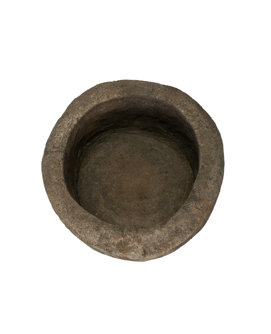 Vintage Indonesian round limestone trough, visible textured interior and rough-hewn rim.