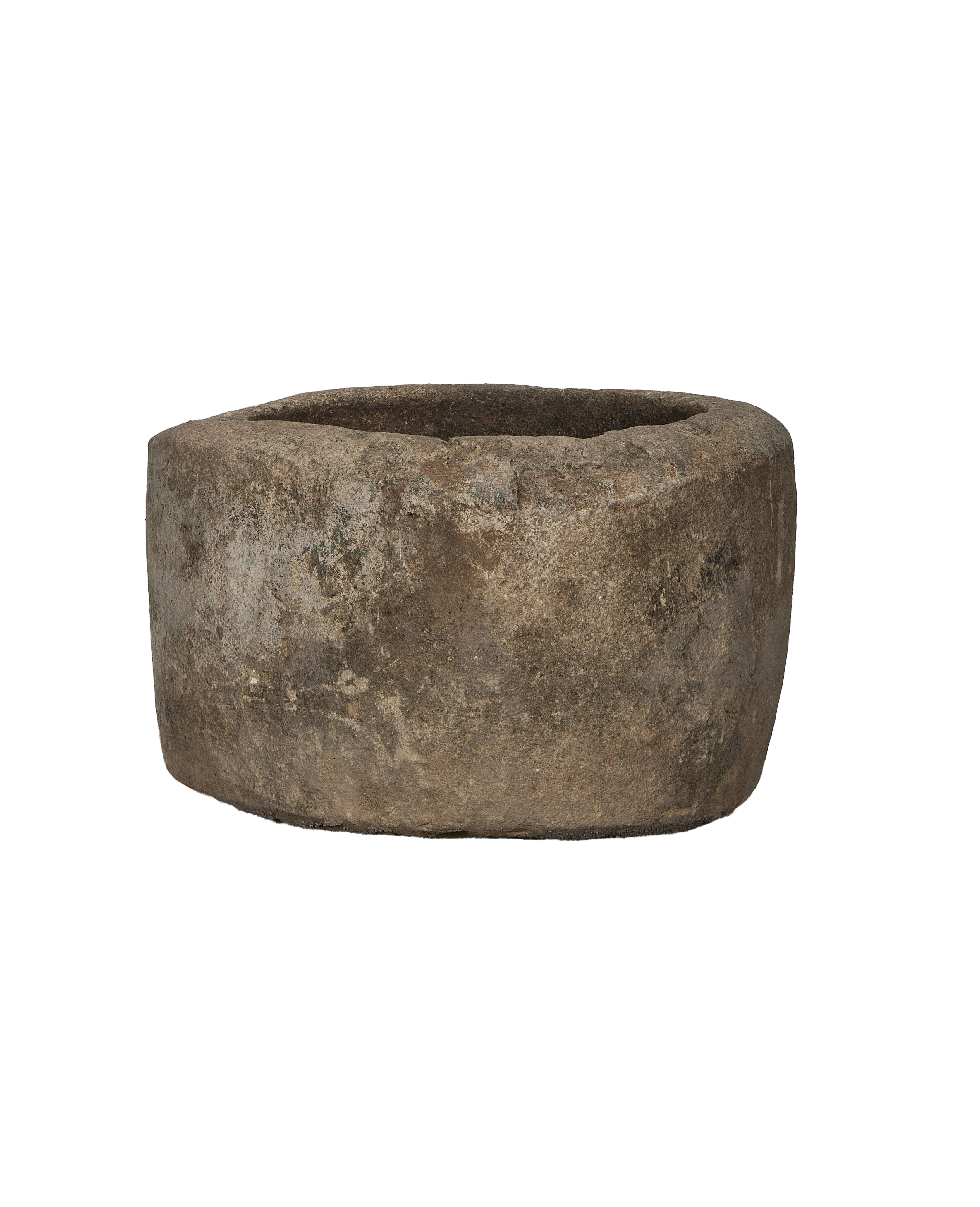 Vintage Indonesian round limestone trough, naturally weathered with textured surface, on black.