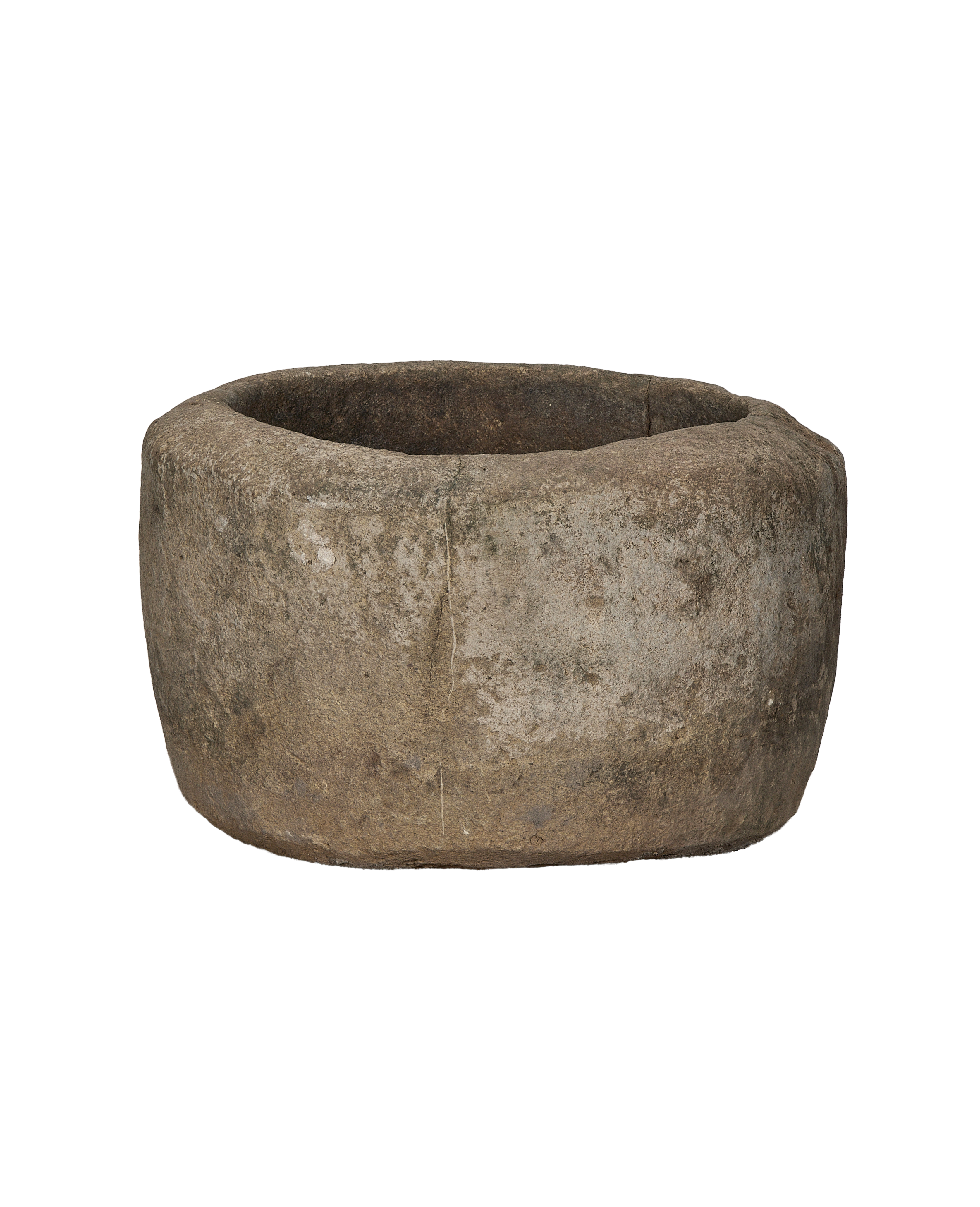 Vintage Indonesian round limestone trough, profile view revealing weathered texture and rustic charm.