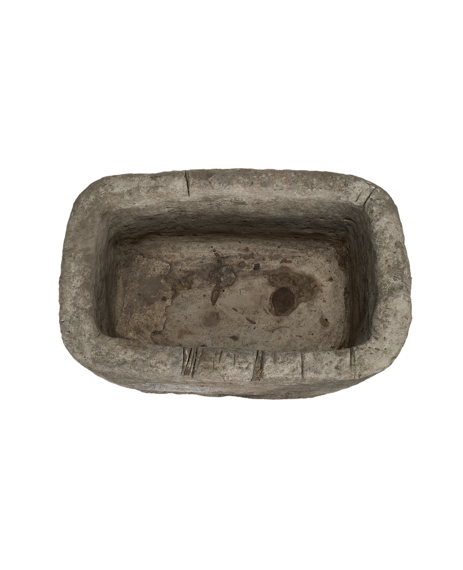 Vintage Indonesian rectangular limestone trough, showing distressed interior with earthy patinas and drain holes.