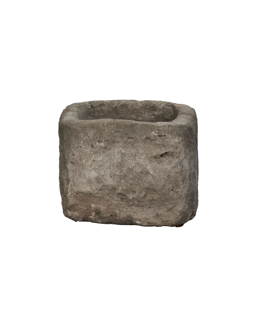 Vintage stone trough from Indonesia, weathered rectangular limestone, medium shot, showing top opening.