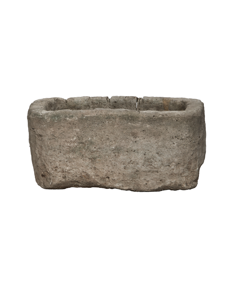 Vintage Indonesian limestone trough, rectangular, rough textured surface with chipped edges, showing its weathered condition.