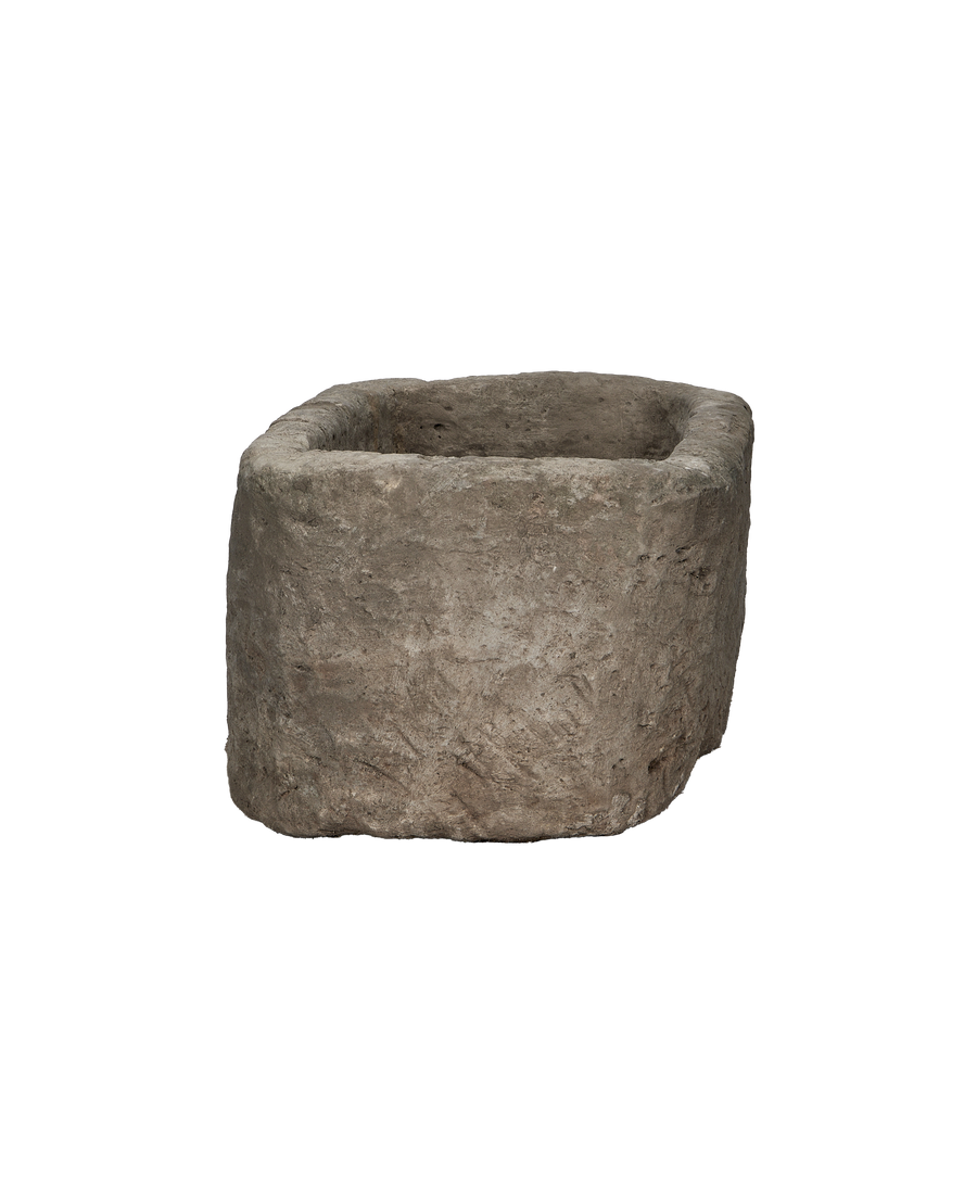 Vintage Indonesian limestone trough, oak, showing rough, textured exterior surface and uneven rim.