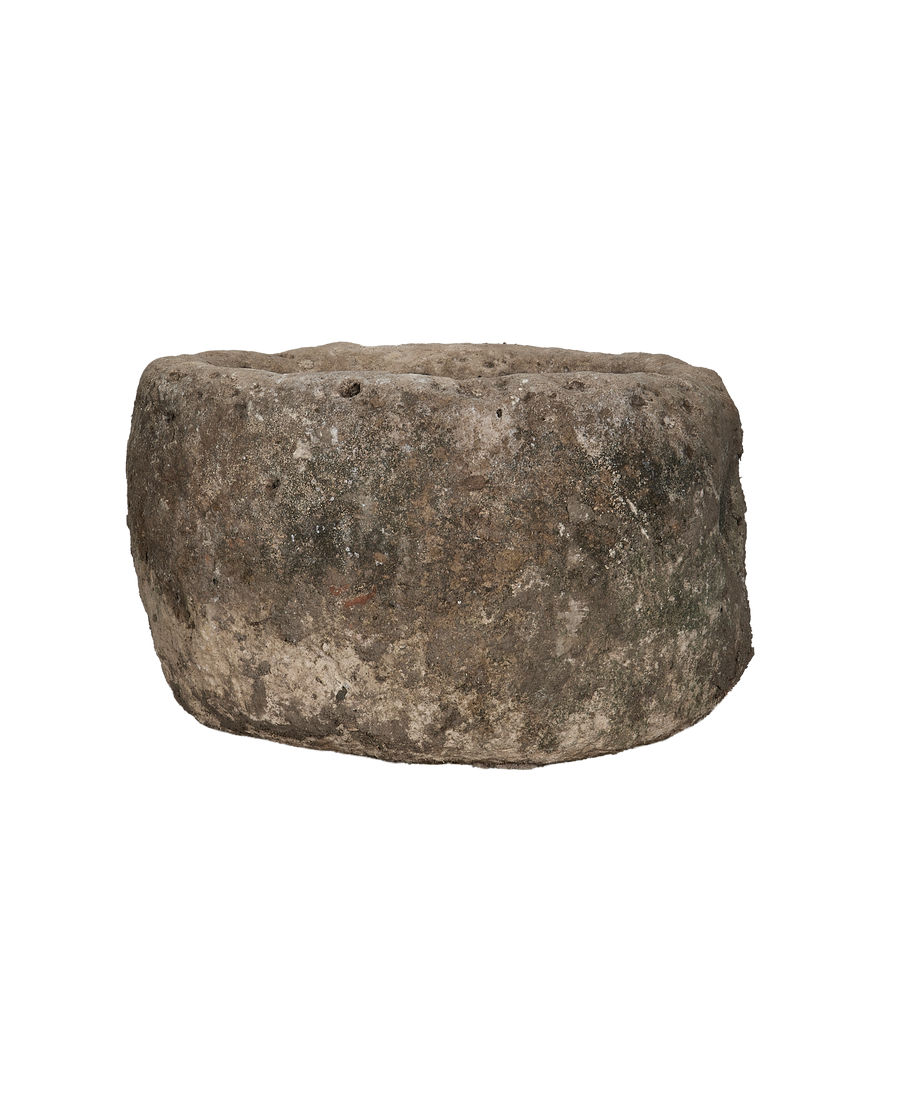 Vintage round limestone trough, aged surface texture detail, rustic Indonesian antique.